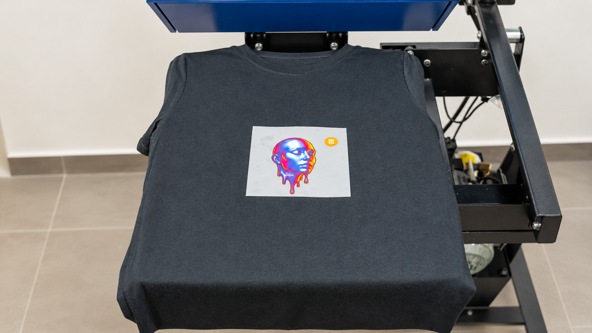 DTF transfer positioned on a charcoal garment before heat pressing