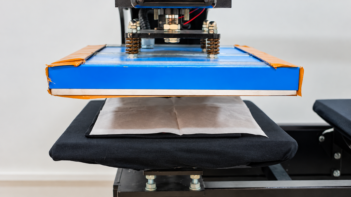 Protective cover sheet placed over a DTF print for the final press