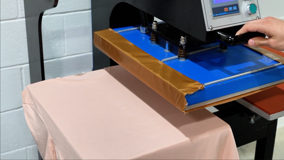 DTF transfer positioned on a charcoal garment before heat pressing